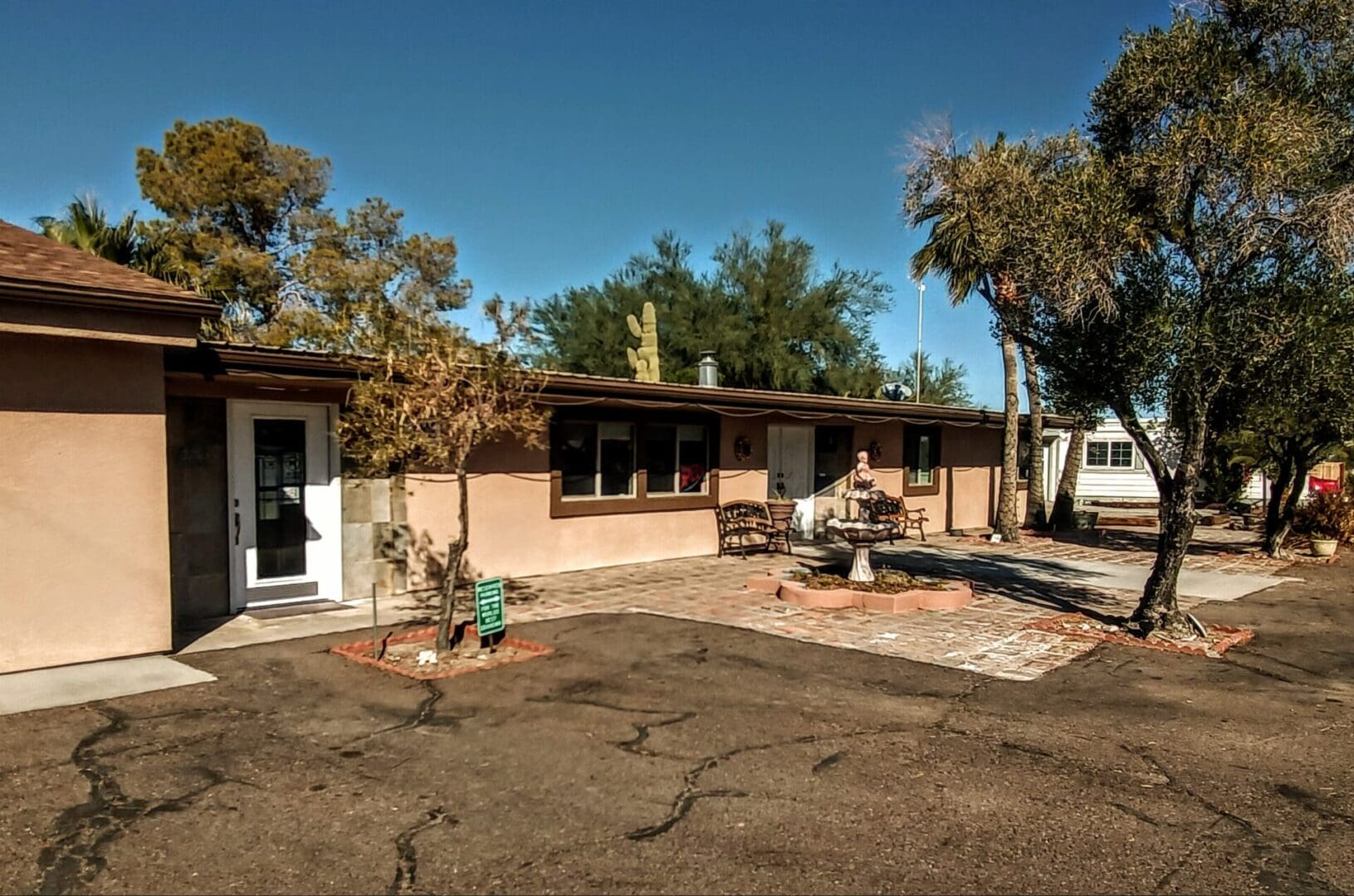 A large brown house with a lot of dirt around it